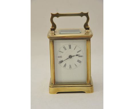 A brass case carriage clock, the enamel dial with Roman numerals