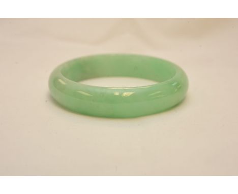 A pale green jadite bangle, 7.5cm approx
