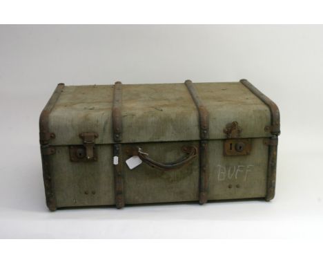 A vintage trunk containing a collection of household cavalry items comprising gloves, belt etc