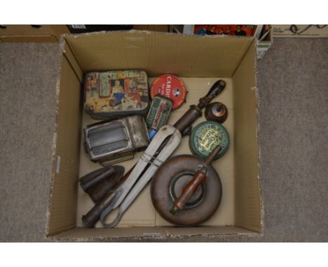 A box containing various items including an old copper camping kettle, an iron, a pump, washing tongs, a carriage lamp and va