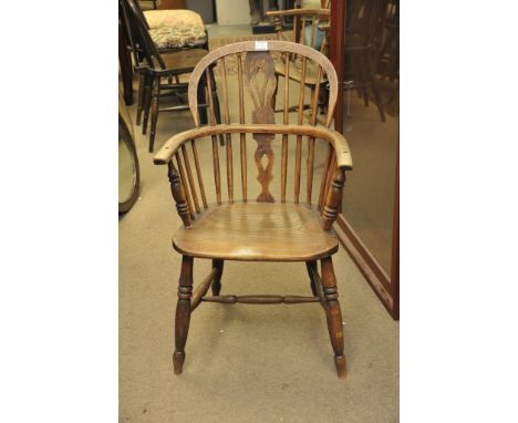 Two elm stick back chairs, the solid seats on turned legs