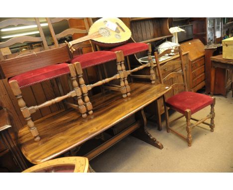 A dark wood Ercol table and four ladder back chairs.