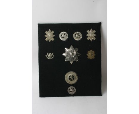 A collection of nine Scots badges including Perth R.V. helmet plate and a London Scottish Plaid brooch