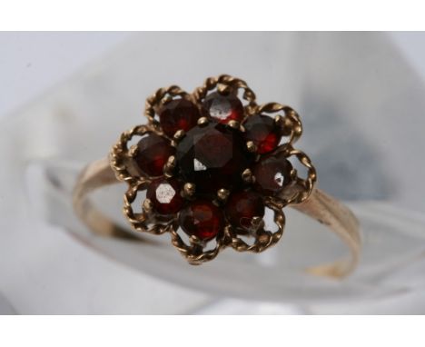 A 9ct gold ring of floral design inset with garnets