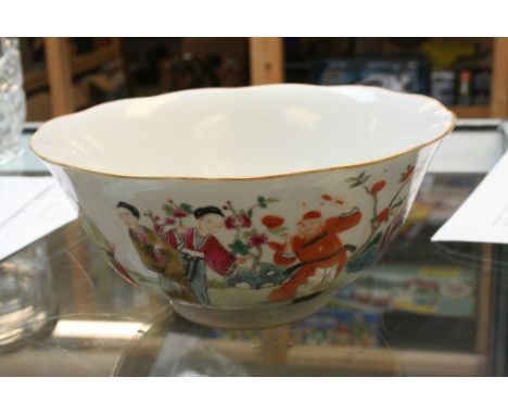 A Chinese bowl decorated with attendants amongst flowers and foliage with seal mark