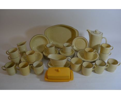 A Poole pottery modern design coffee and dinner service with red speckled finish on a yellow ground.