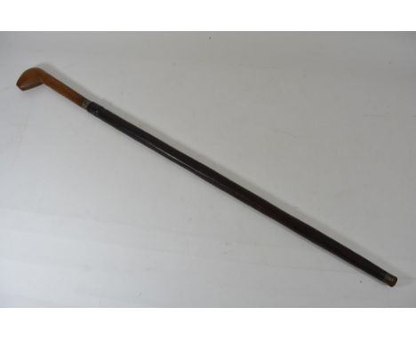 An unusual late 19th Century colonial sword stick with a carved handle and leather sheath