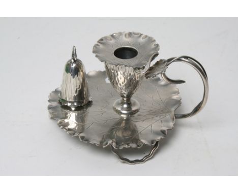An unusual silver plated candlestick formed as a flower on a leaf