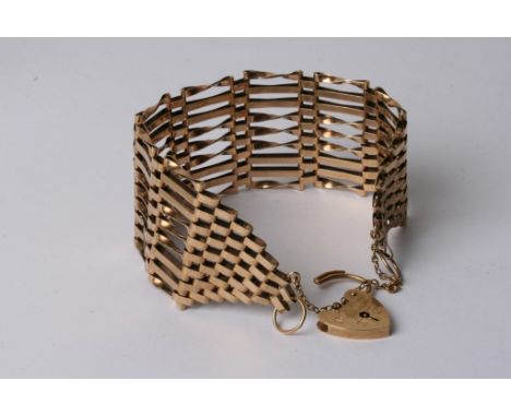 A gold gate bracelet with heart clasp