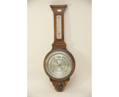 An oak barometer with applied thermometer