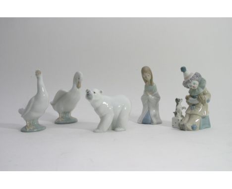 A Lladro polar bear, clown and figure of a lady with two other Nao models 