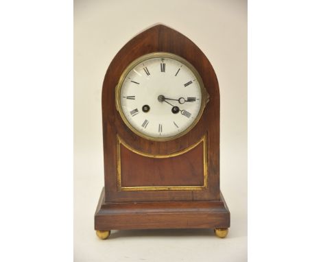 An Edwardian Walnut arch top mantel clock with French movement.