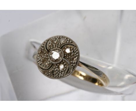 An 18ct gold and platinum diamond ring of circular design