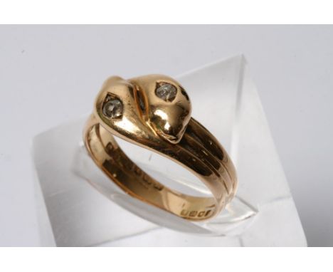 An 18ct gold ring in the form of intertwining snakes, inset with old cut diamonds