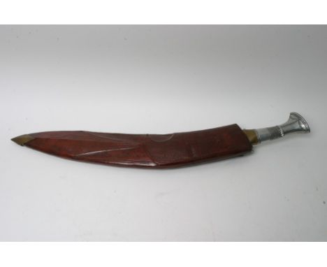 A large kukra type knife with a metal grip and leather scabbard