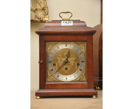 A modern reproduction Mahogany mantle clock.