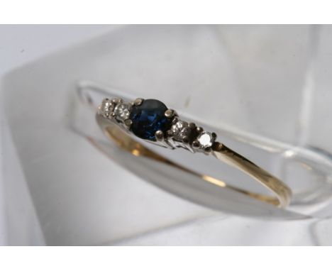 An 18ct gold blue sapphire and diamond ring