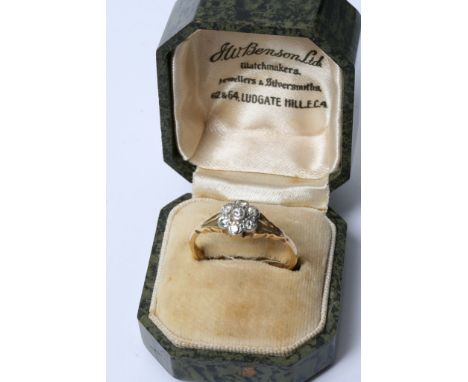 An 18ct gold and platinum ring set with diamonds in the form of a flower in a fitted box