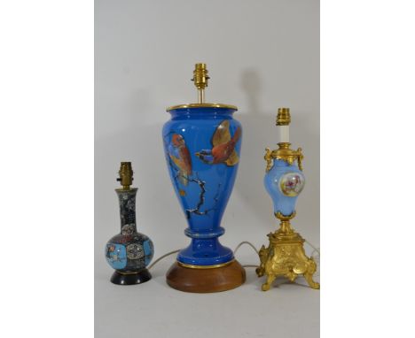 A small cloisonne lamp, a large glass lamp painted with birds and a painted ceramic example