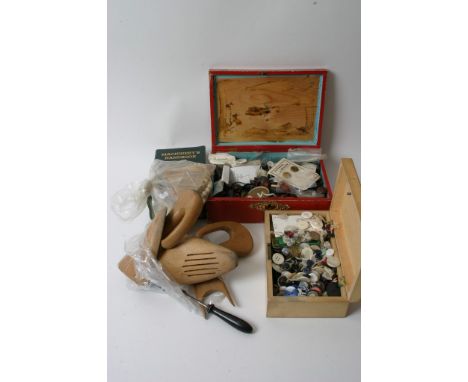 A collection of vintage buttons, ivory beads and sewing tools
