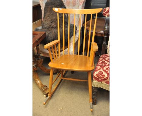 A set of four ercol dining chairs and a stick back rocking chair