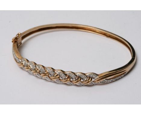 A 9ct gold and diamond studded bangle