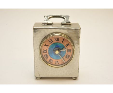 A small hammered pewter clock by Liberty & Co. with blue enamel dial and copper chapter ring (later movement fitted, original