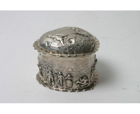 A quality silver gilt heart shaped trinket box, repousse decorated with a band of figures, the lid with children on a see saw