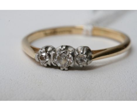 An 18ct gold ring with three old cut diamonds.