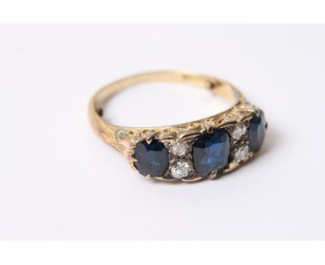 A vintage gold ring set with a row of sapphires and diamonds, in fitted box