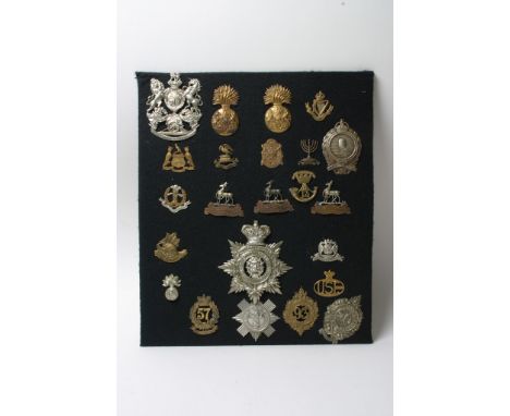 A collection of 23 various badges and helmet plates most of which are retrospective copies
