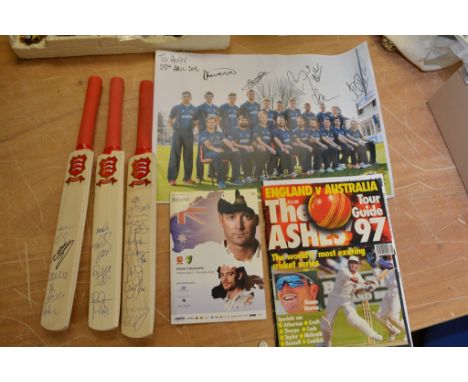A collection of cricket memorabilia including miniature cricket bats signed by 12 players from the 2015 Australia test squad,