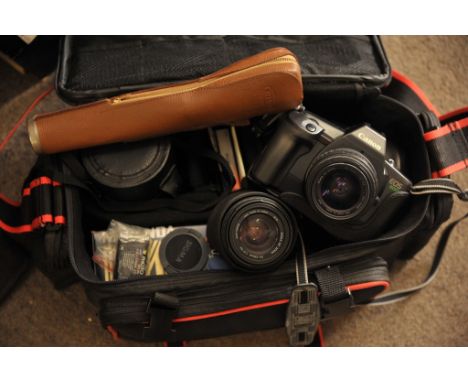 A cased Canon EOS 600 camera plus a Sigma lens and flash gun
