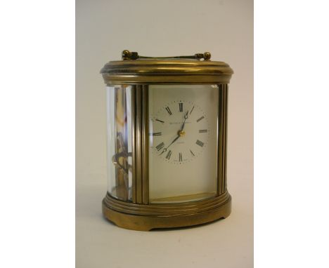 A Matthew Norman brass cased carriage clock, the white faced enamel dial having a Roman numeral chapter ring.