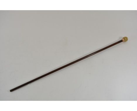 A Victorian walking stick mounted with a Japanese carved ivory 'Thousand Faces' ball