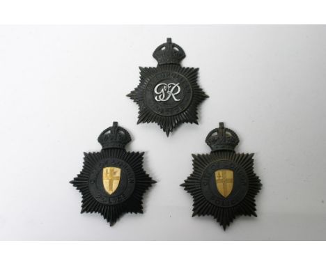 Three post 1953 police helmet plates comprising two Kings Crown, City of London and a Kings Crown Metropolitan, minus one lug