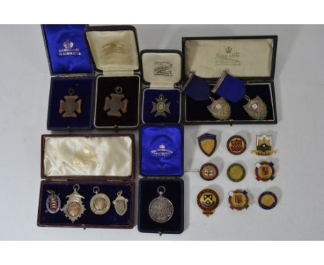 A collection of SFRC Silver and enamel shooting medals and various other medals and badges