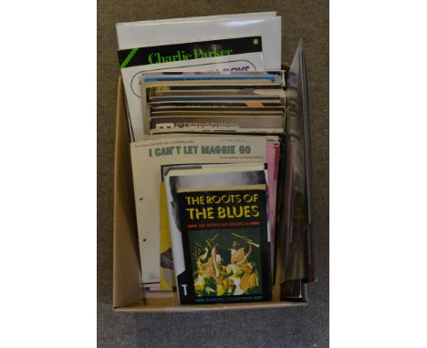 A box containing a collection of books, music sheets, Beat Instrumental magazines, a Bob Dylan book etc