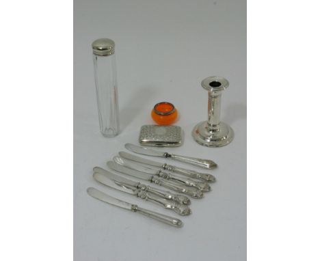 A collection of silver items to include cigarette case, candlestick, silver handled butter knives etc