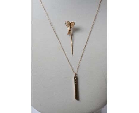 A 9ct gold and diamond pendant with a gold chain and a stick pin in the form of tennis rackets