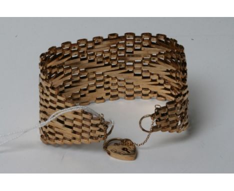 A large and wide 9ct gold gate bracelet with a padlock clasp