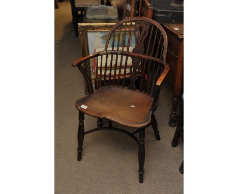 An elm stick back chair, the turned legs united by a hoop stretcher