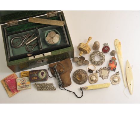  A late Victorian gold ring set with garnets a Scottish silver brooch and other oddments and a green (2)