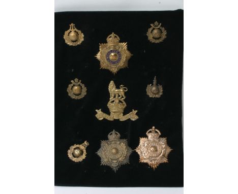 A collection of nine various royal marines badges helmet plates etc, some retrospective copies