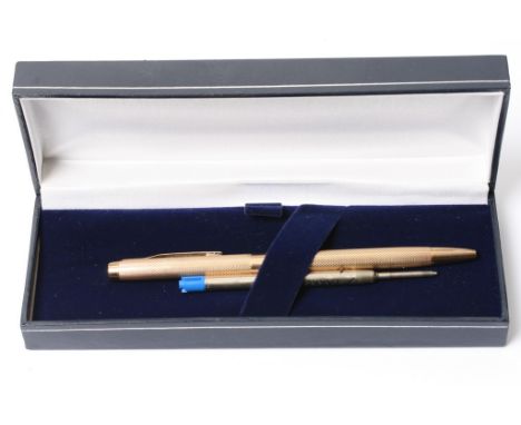 A 9ct gold cased pen with engine turned decoration, makers initials W. M.