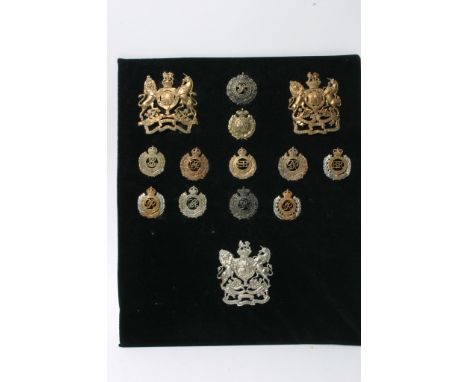 A collection of 11 different Royal Engineers cap badges and three helmet plates, some of which are retrospective copies