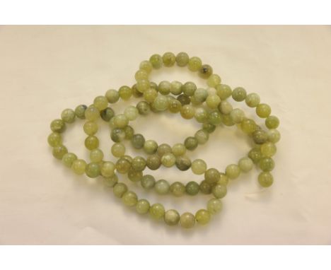 A 20th century jade bead necklace , approximately 61 cm long