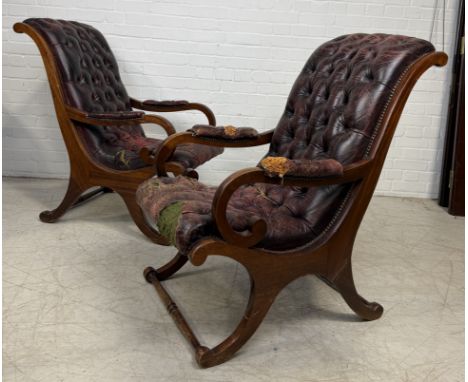 A PAIR OF SLIPPER ARMCHAIRS UPHOLSTERED IN OX BLOOD BUTTON BACK LEATHERFor reupholstery.98cm x 98cm x 56cm