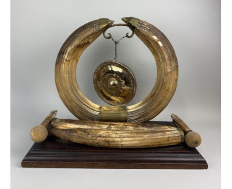 A LARGE VICTORIAN HIPPO TUSK GONG WITH ENGRAVED PLAQUE 'SHOT IN THE SOBAT RIVER...XMAS 1889'With stand 61cm x 52cm
