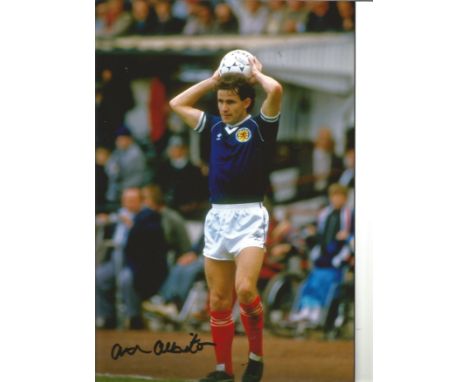 Football Arthur Albiston 12x8 Signed Colour Photo Pictured Playing For Scotland. Good Condition. All autographs are genuine h